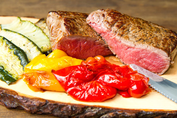 Delicious beef steaks on wooden table