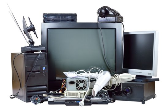 Old and used electric home waste. Obsolete pc computer, telephone, CRT monitor, DVD.