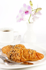 Delicious croissant with a cup of black coffee