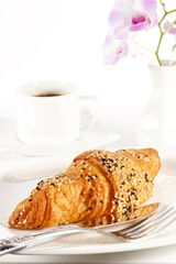 Delicious croissant with a cup of black coffee