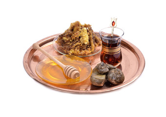 .honey  and wooden stick ,cup of Turkish tea