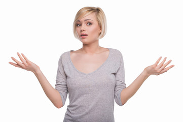 Frustrated woman. Surprised young woman gesturing and looking at