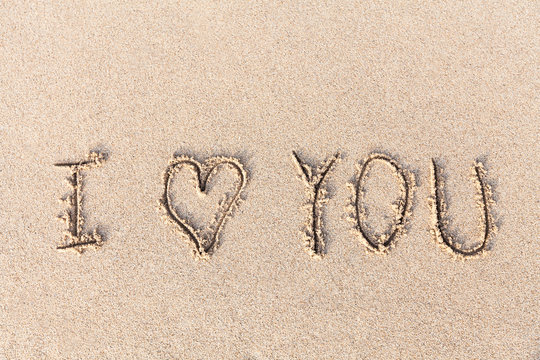 I love you handwritten in sand for natural