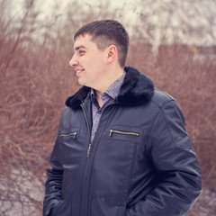 Portrait of a young man in a winter forest