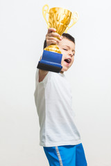 Little boy celebrates his golden trophy