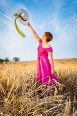 young beautiful woman in golden wheat field