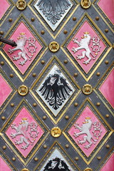 Wooden door with emblems in St. Peter and Paul church in Prague