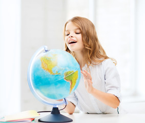 student girl with globe at school