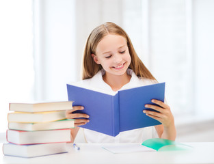 Fototapeta na wymiar girl studying and reading book at school