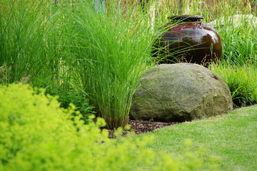 Detail from the garden with wet ceramic vase