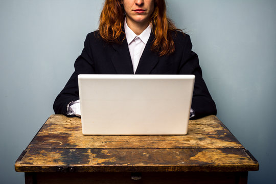 Serious businesswoman working on laptop