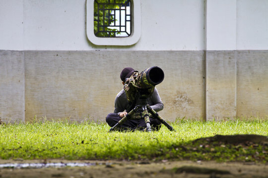 man taking pictures with camera len