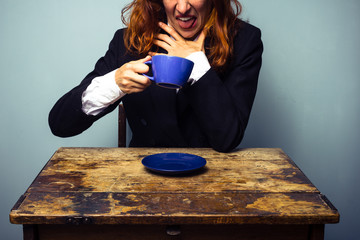 Businesswoman has had a very bad cup of coffee