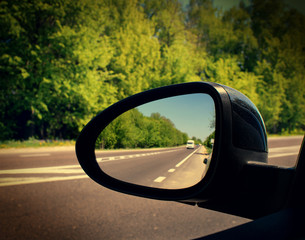 mirror of the car with the road