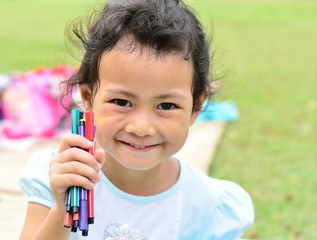 Going back to school : Little girl holding color pens