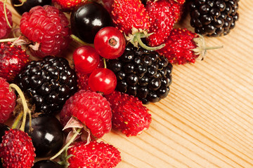 Ripe Berries on Wooden Background