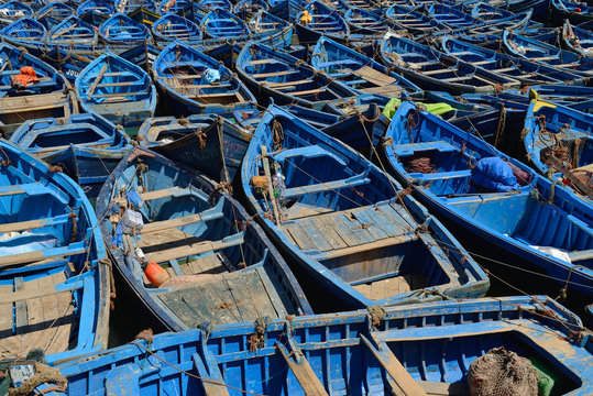 Small wooden blue fishing boats in harbor of Essaouira, Morocco