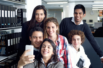 Group of teenagers taking a self portrait with smart phone