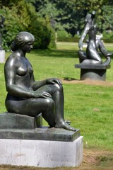 Sculpture of a woman sitting dawn