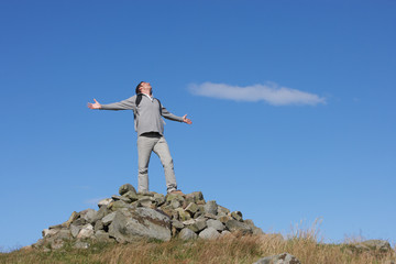 Obraz premium Male Walker Standing On Pile Of Rocks