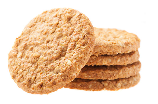 a pile of oats biscuits on a white background