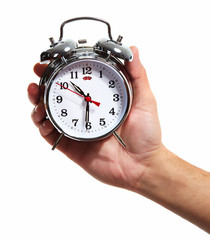 Hand with alarm clock.