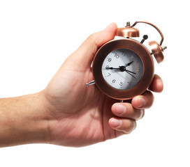 Hand with alarm clock.