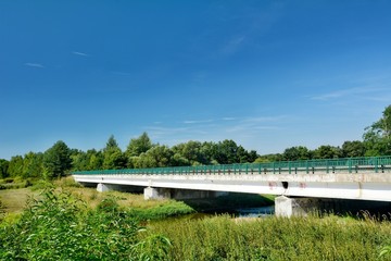 Old concrete road bridge over the river.
