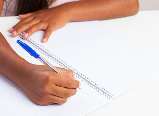 latin girl writing in a notebook