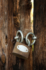 Old padlock on a wooden door