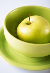 green apple in green bowl