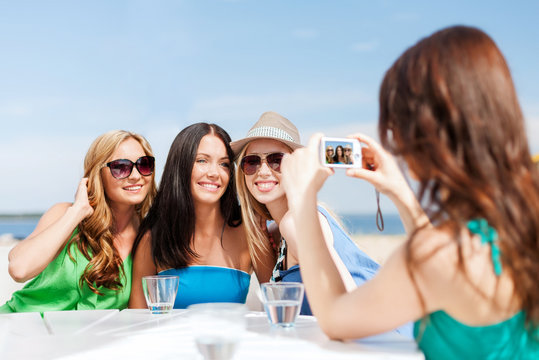 girls taking photo in cafe on the beach