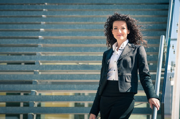 Fototapeta premium Business woman portrait outdoors with modern building as backgro