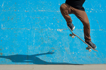 Skateboarder doing a skateboard trick - ollie - at skate park. - obrazy, fototapety, plakaty
