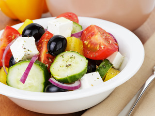 fresh greek salad in white bowl