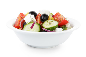 fresh greek salad in white bowl