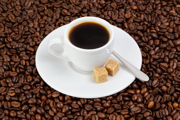 cup of coffee in coffee beans
