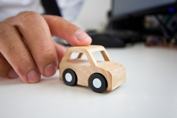 Wooden car on a table.