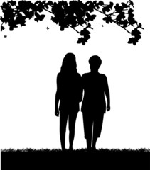 Mother and daughter walking in park silhouette