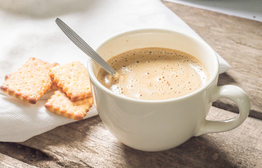 Creamy coffee with biscuit.
