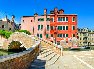 Venice cityscape, water canal, bridge and traditional buildings.