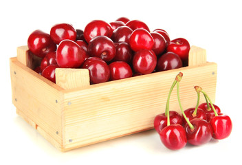 Cherry berries in wooden box isolated on white