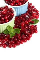 Ripe red cranberries in bowls, isolated on white.