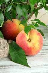 Ripe sweet peaches on wooden table, close up