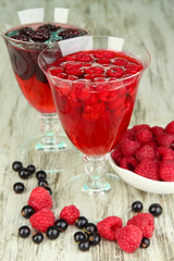 Jelly with fresh berries on wooden table close up