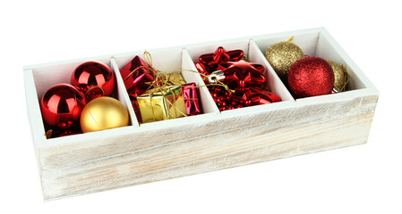 Wooden box filled with christmas decorations, isolated on white