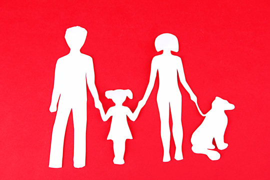 Family from paper on bright background