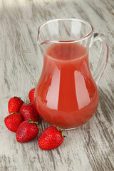 Delicious strawberry juice on table close-up