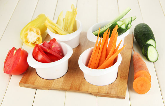 Bright fresh vegetables cut up slices in bowls