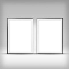 Two empty frames on a wall